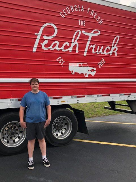 Grant in front of peach truck