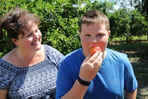 eating a peach at a farm