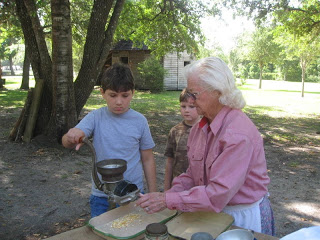 grinding corn on a homeschool field trip