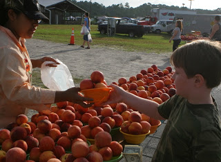grant buying peaches at the farmers market