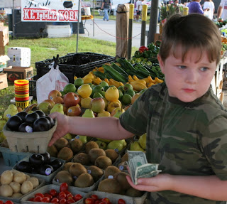 buying plums on a homeschool field trip to the farmers' market