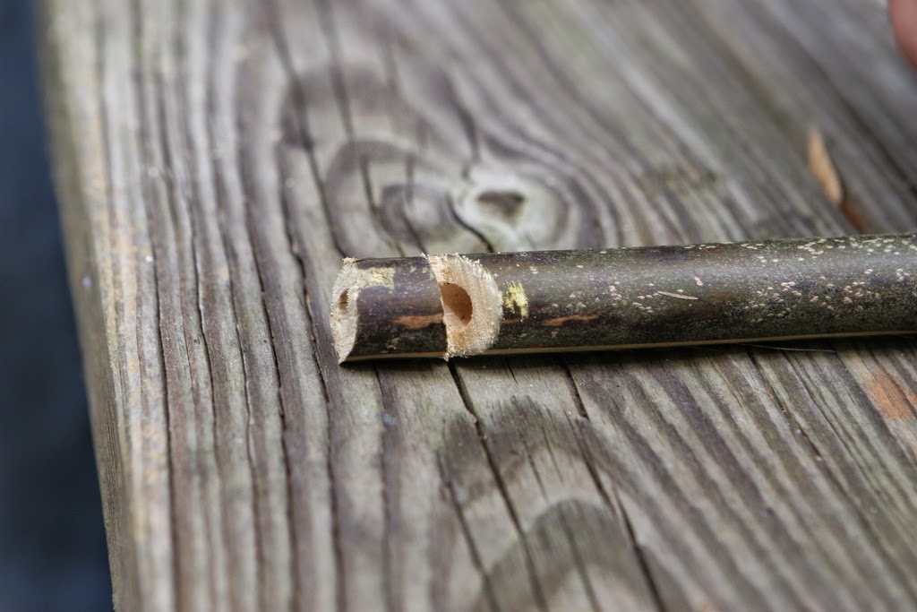 Carving a wooden bamboo whistle
