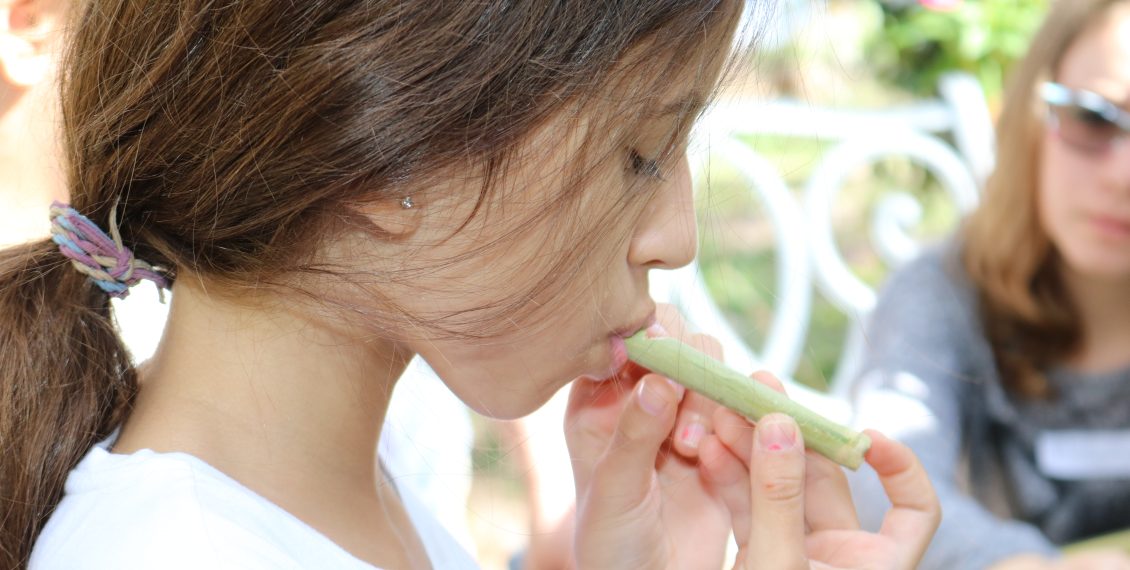 blowing a handmade whistle