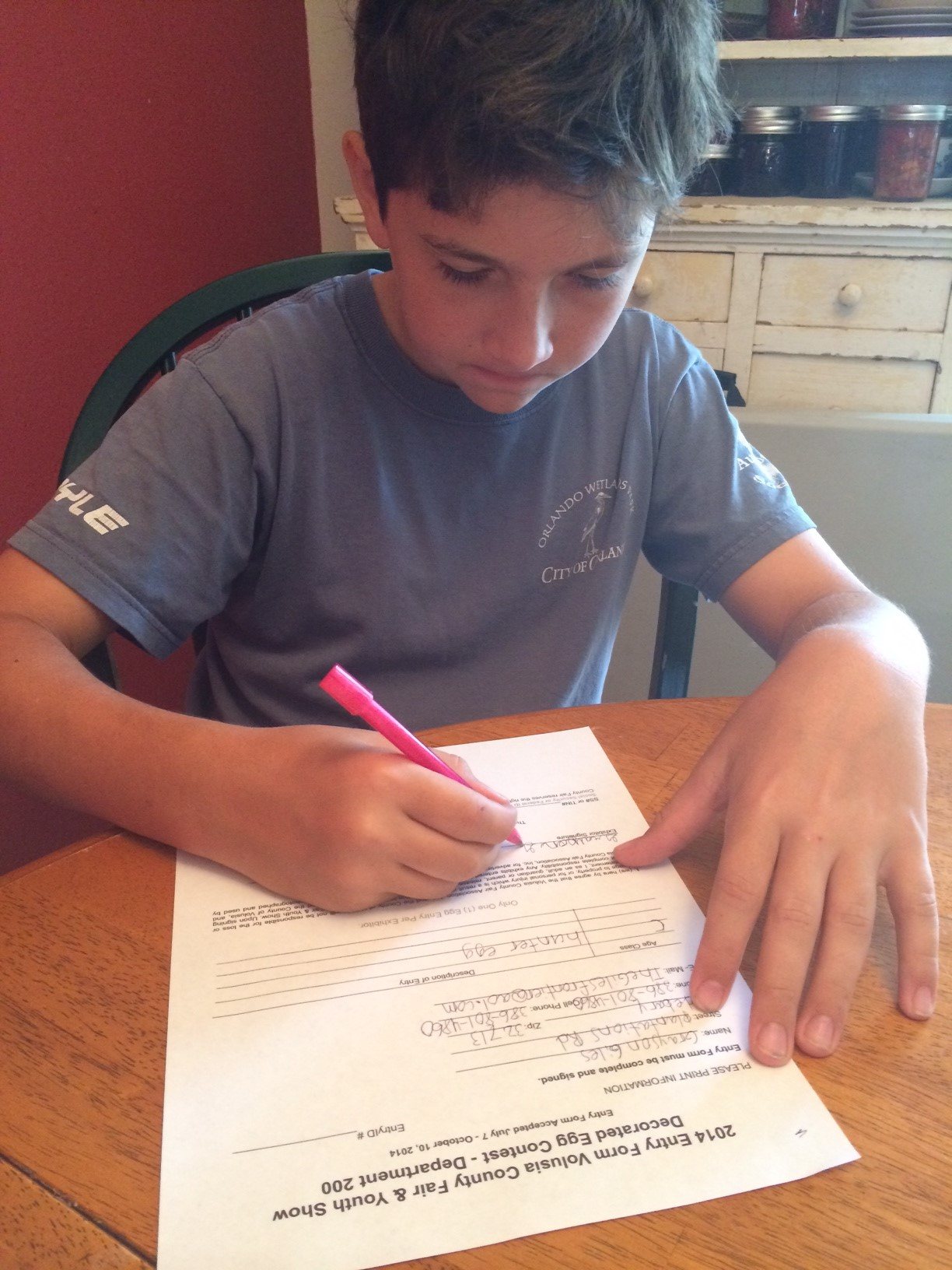 grayson filling out the application for the fair