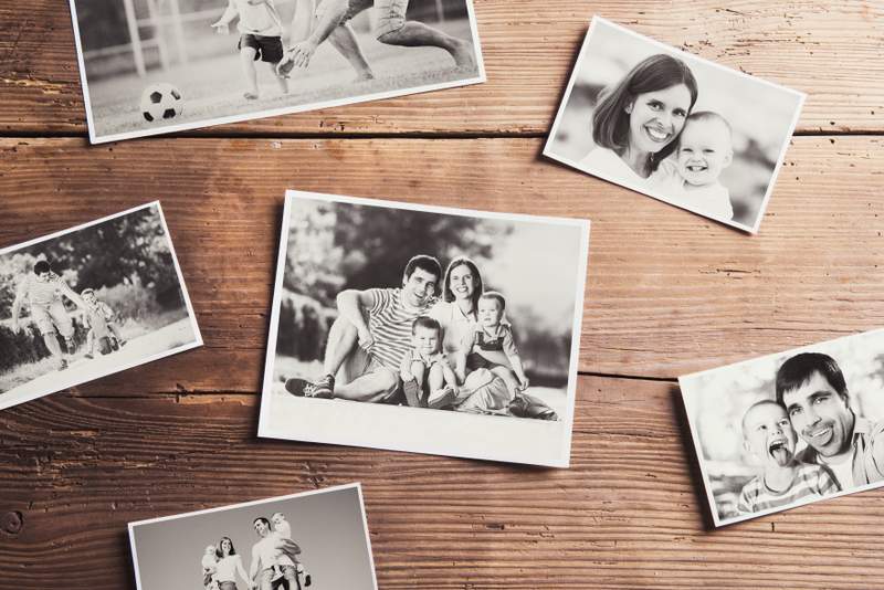 Family photos laid on a table building pioneer family relationships